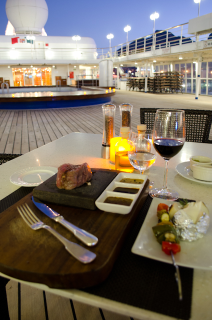 Dinner poolside at The Grill, featuring Silversea's fun Hot Rocks dining concept; a "must-do" feature. Photo © 2013 Aaron Saunders