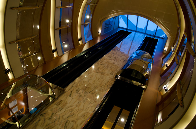 Flanked by glass elevators and topped with a skylight, the Atrium aboard Hurtigruten's Midnatsol is unusually elaborate. Photo © 2013 Aaron Saunders